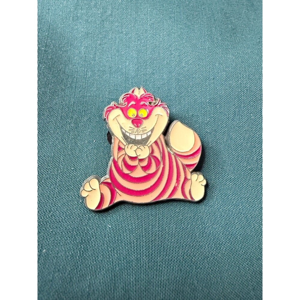 Disney pin featuring the Cheshire Cat from Alice in Wonderland